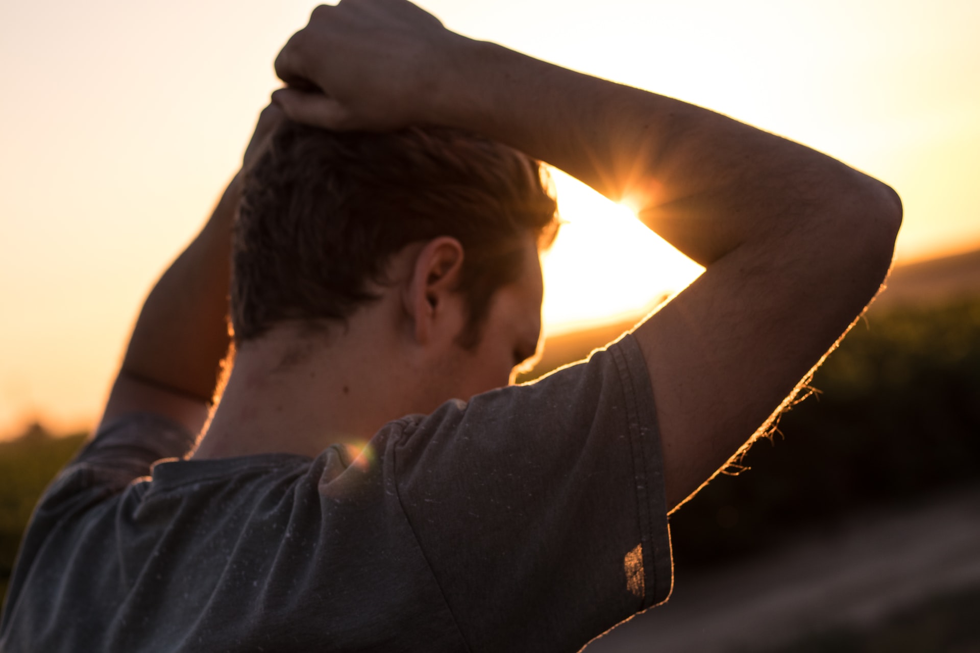 a person resting his hand on his head